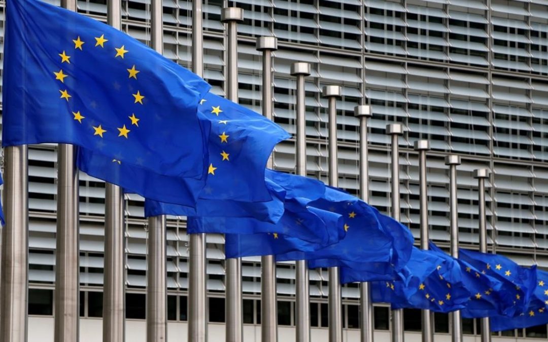 EU flags are lowered at half-mast in honor of the victims of the Manchester attack outside the EU Commission headquarters in Br